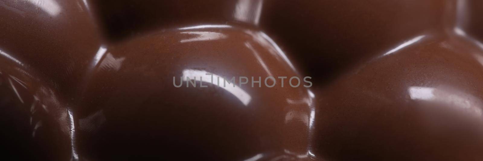 Closeup of bar of airy aerated milk chocolate background. Delicious food in cafe concept