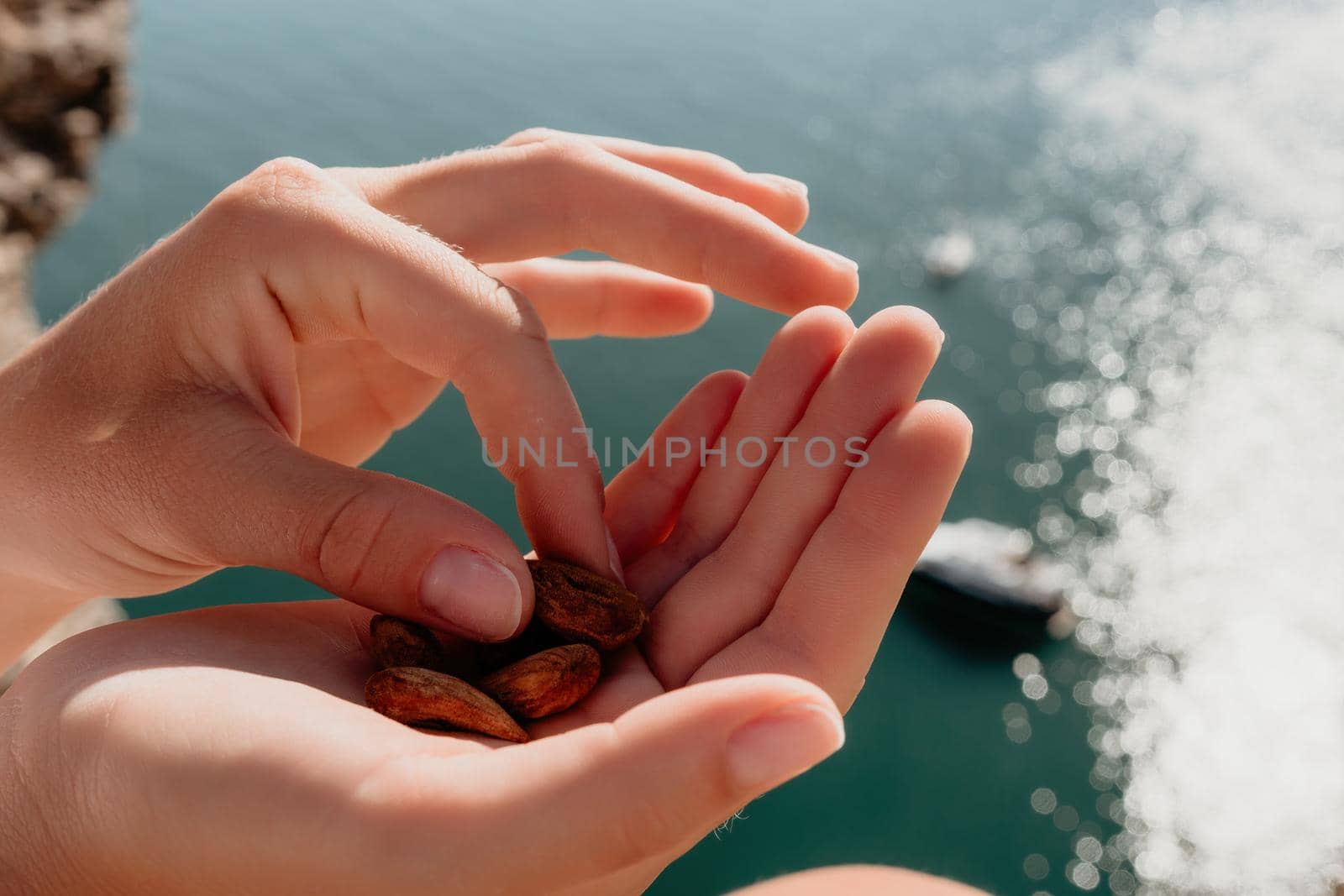 Unrecognizable caucasian woman eating young milky almond nuts. Healthy vegan food