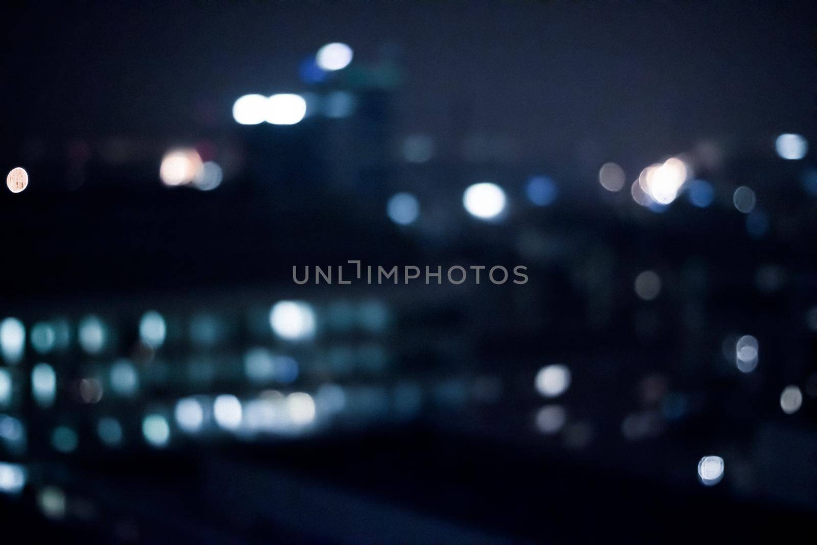 Blurry metropolitan district - night life, abstract background and modern dark tones concept. Big city comes alive at night