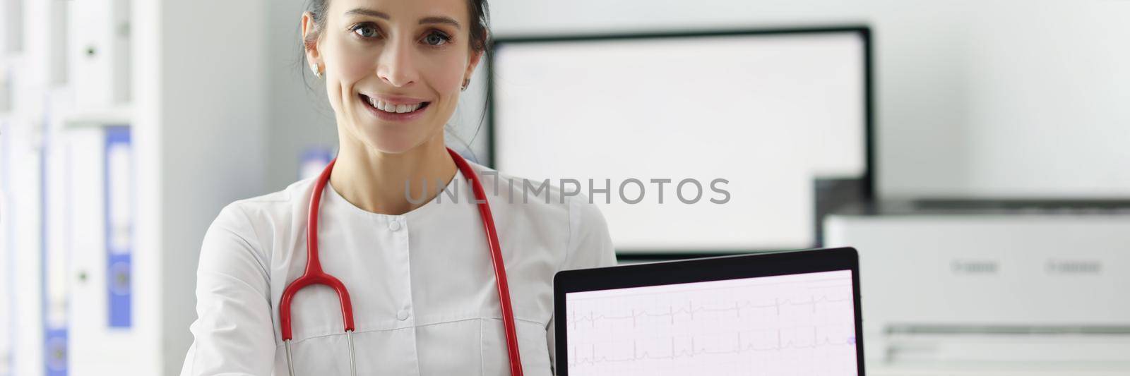 Doctor cardiologist showing electrocardiogram on digital tablet. ECG decoding concept training course