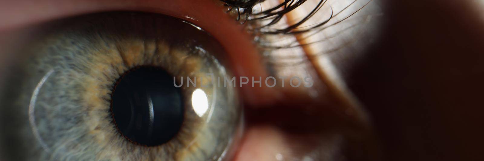 Female eye with black painted eyelashes closeup. Laser vision correction concept