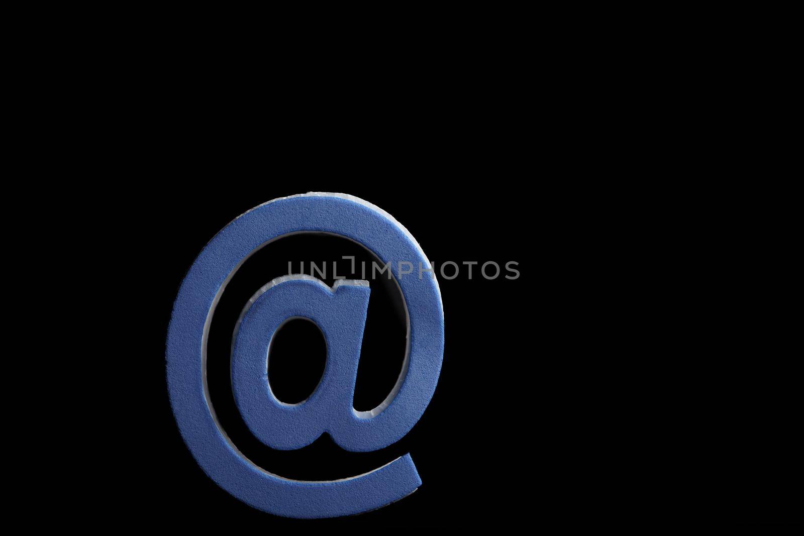 close-up of the blue arroba symbol on a black background