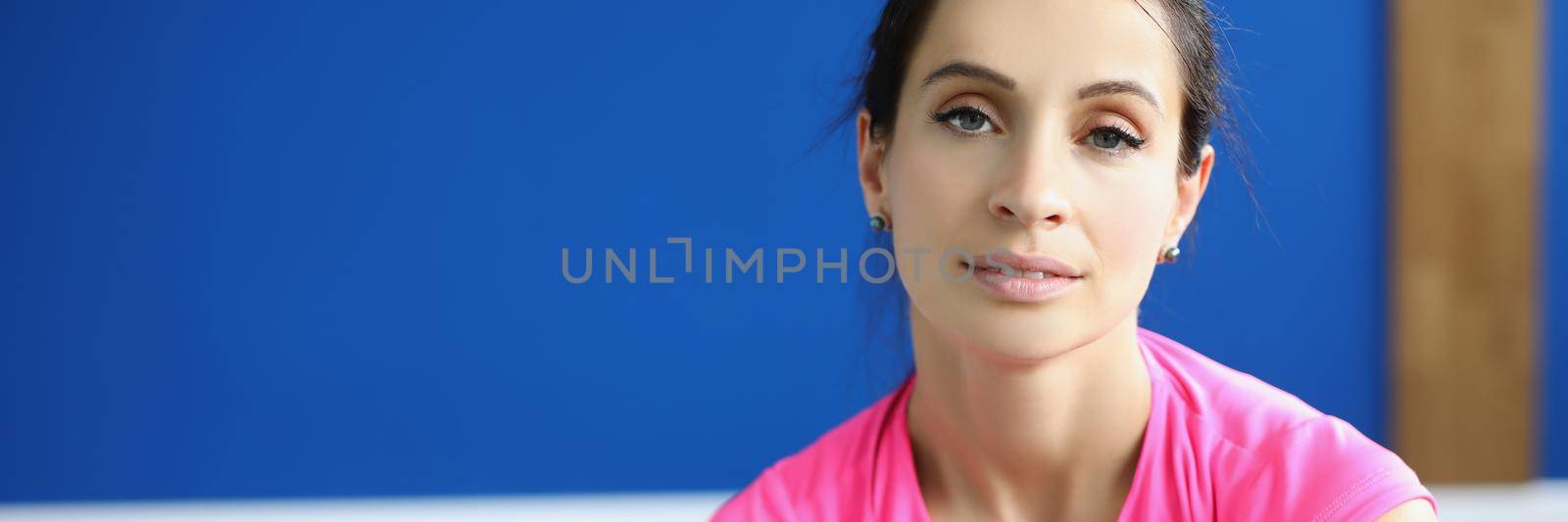 Portrait of tired female athlete after training in gym by kuprevich