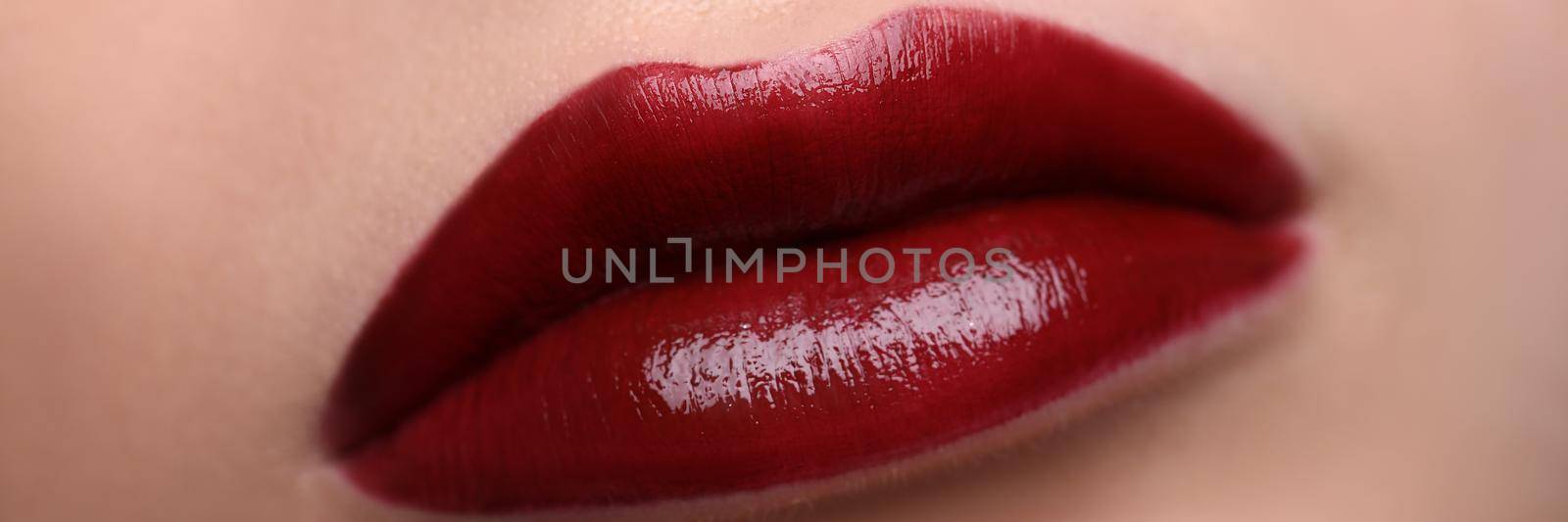 Closeup of beautiful female lips with red lipstick. Professional makeup concept