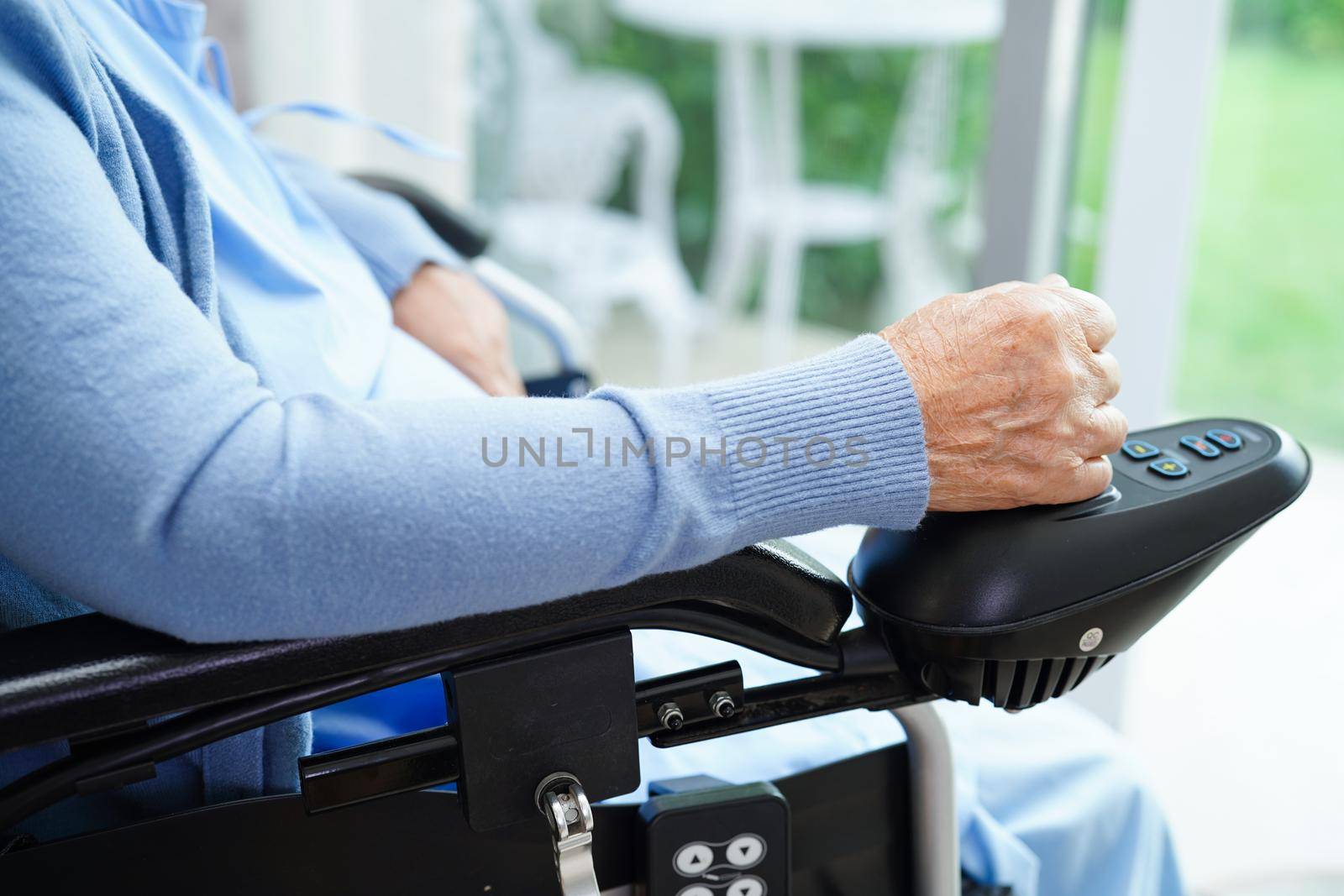 Asian elderly woman disability patient walk with walker in nursing hospital, medical concept.