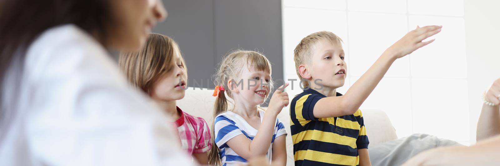 Children and parents playing board games at home. Family leisure concept