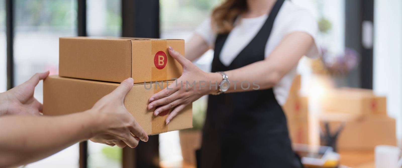 customer receiving a cardboard boxes parcel from delivery man in the morning, delivery service concept