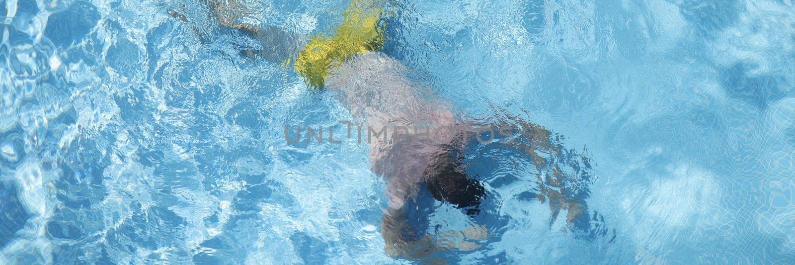 Man lying at bottom of swimming pool top view. Drowning aid concept