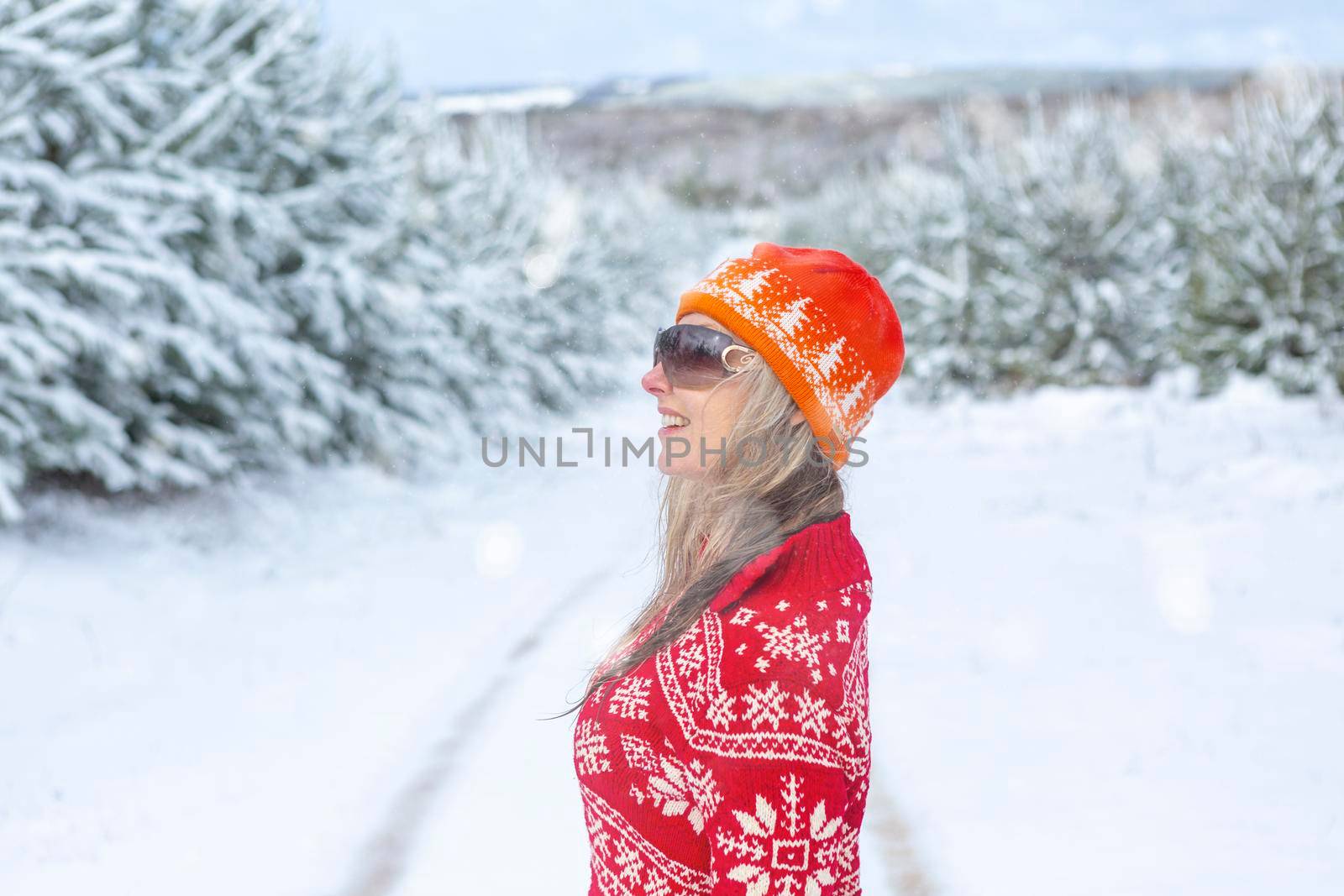 Smiling woman standing in a snow covered landscape winter scene by lovleah