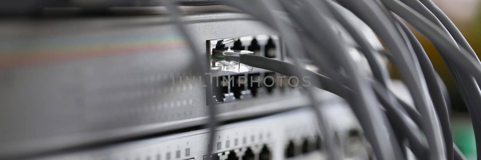 Optical mains cables connected to main server closeup. Telecommunication concept