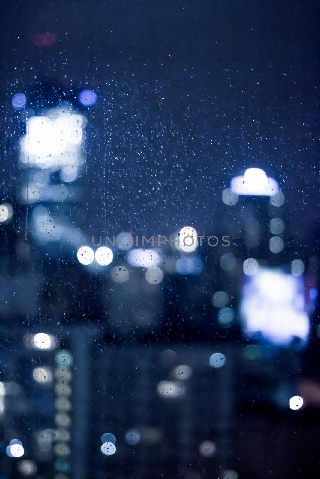 Blurry metropolitan district - night life, abstract background and modern dark tones concept. Big city comes alive at night