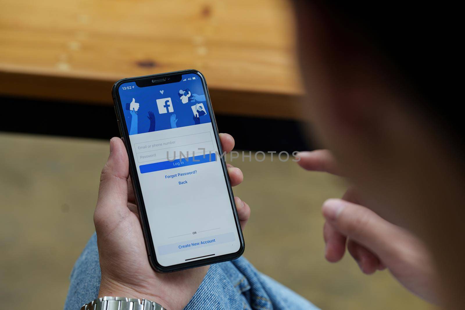 CHIANG MAI, THAILAND - AUG 25, 2022 : A man holds Apple iPhone with facebook application on the screen.facebook is a photo-sharing app for smartphones. facebook is a social network.