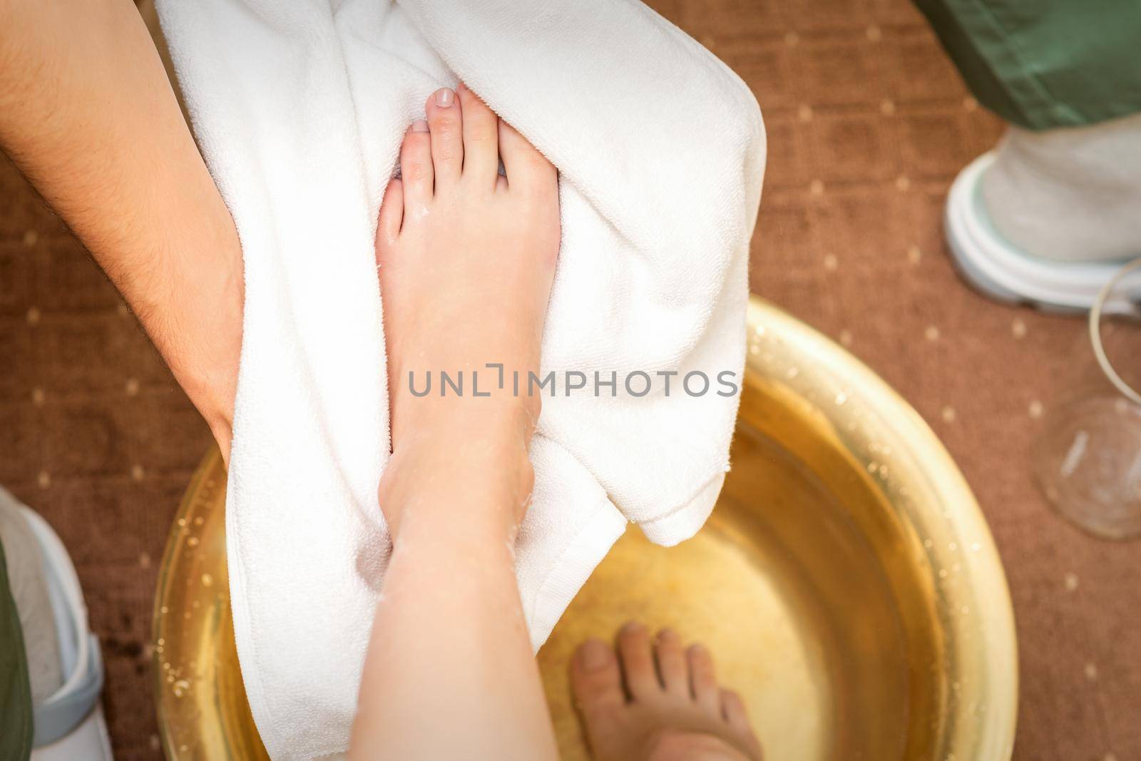 Therapist drying leg with towel by okskukuruza