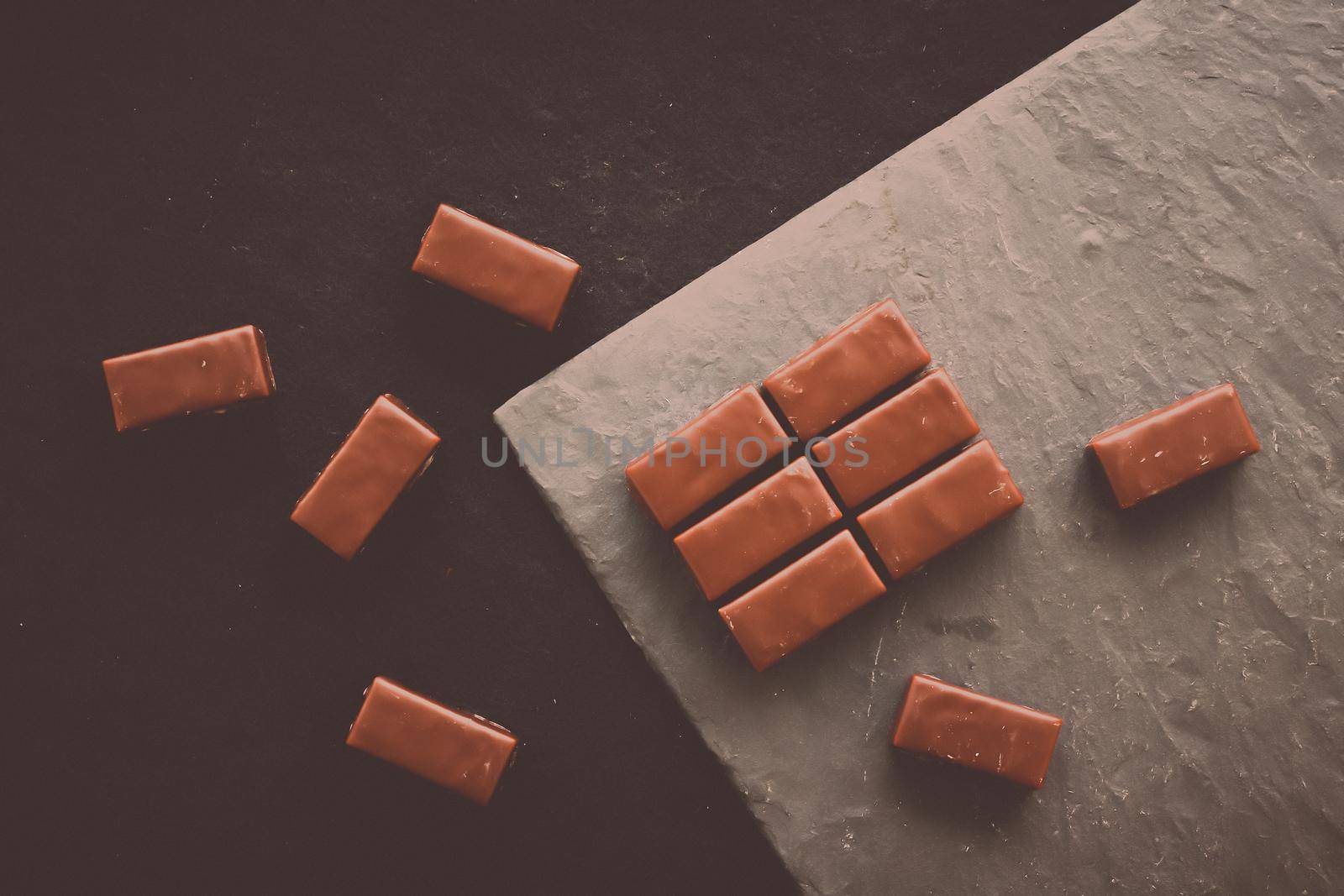 Sweet swiss chocolate candies on a stone tabletop, flatlay - desserts, confectionery and gluten-free organic food concept. All you need is chocolate