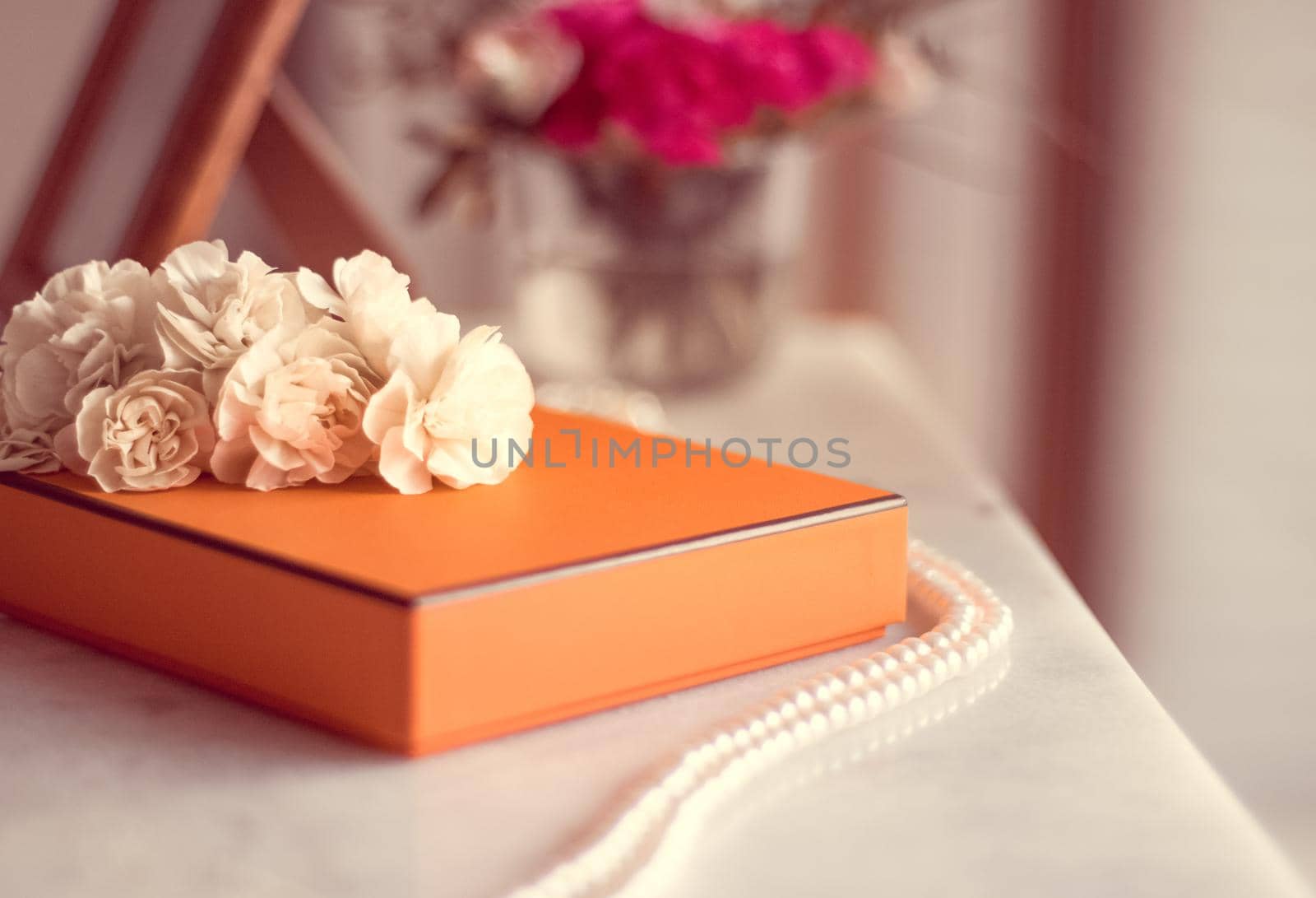 Present box and flowers for her - Mother's day ideas, happy giving and holiday inspiration concept. The perfect gift for mom