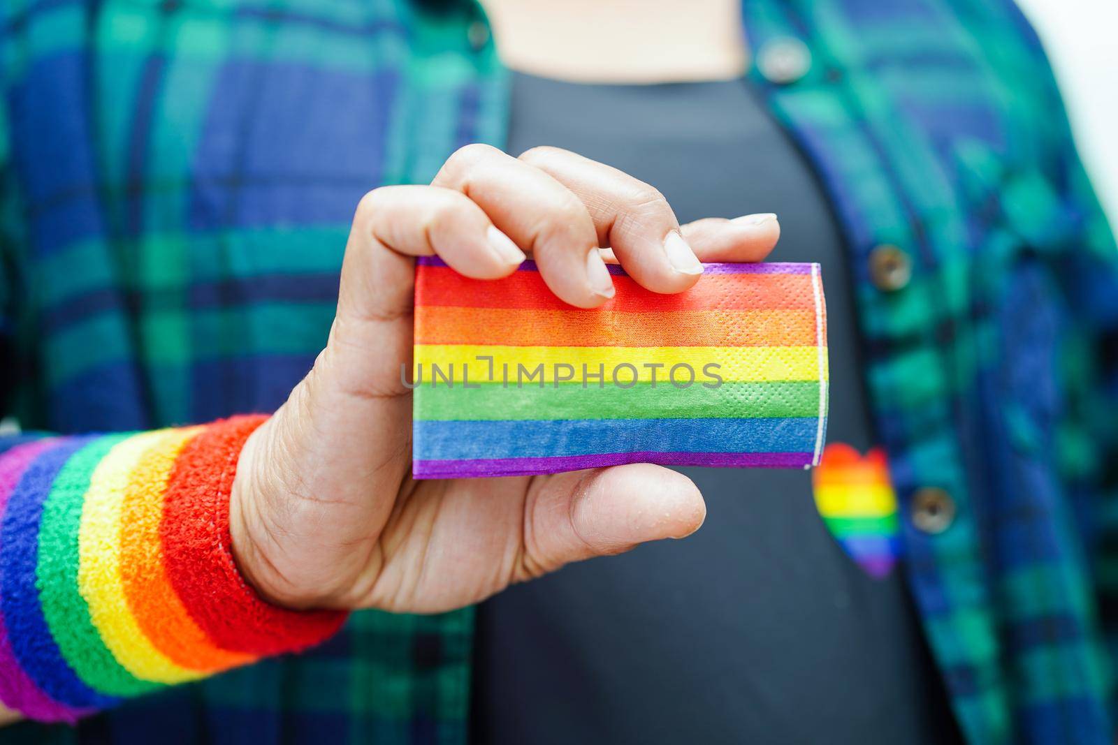 Asian woman with rainbow flag, LGBT symbol rights and gender equality, LGBT Pride Month in June.
