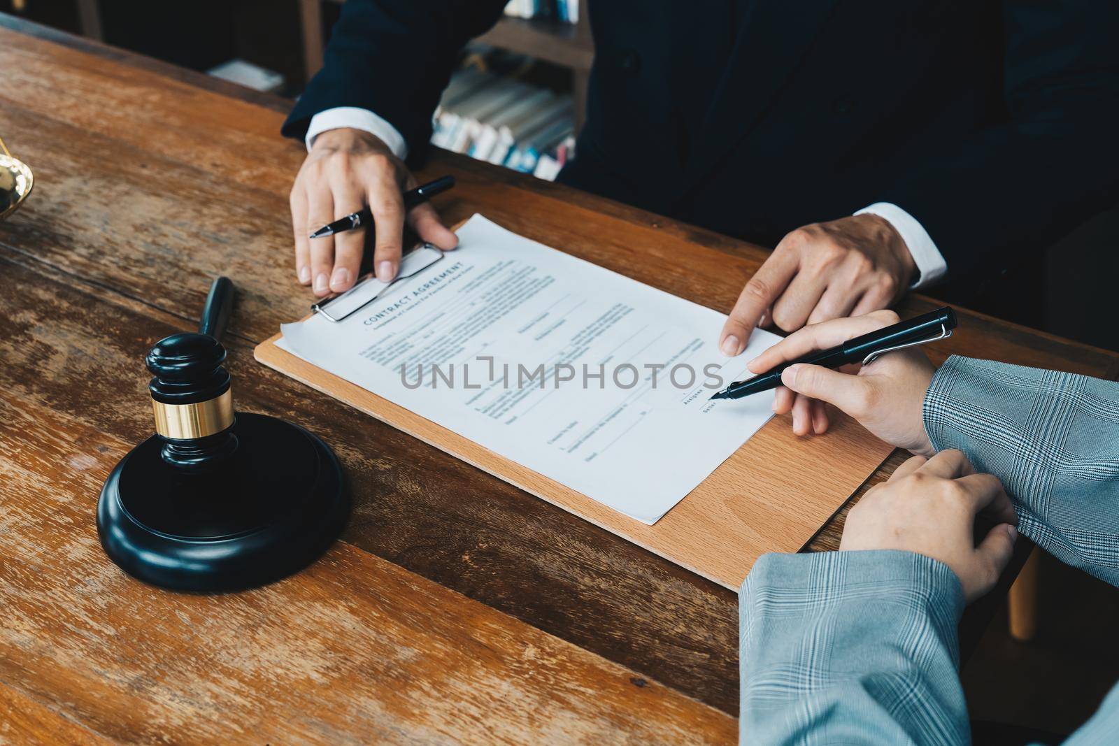 business people and lawyers discussing contract papers sitting at the table. Concepts of law, advice, legal services.