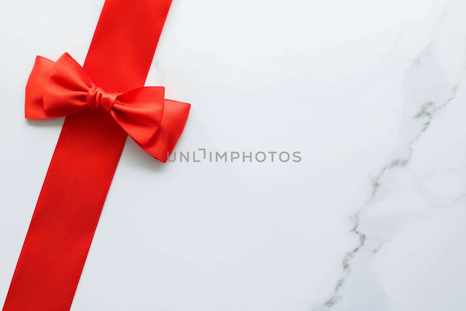 Holiday decor, feminine design and flatlay concept - Red silk ribbon on marble, top view