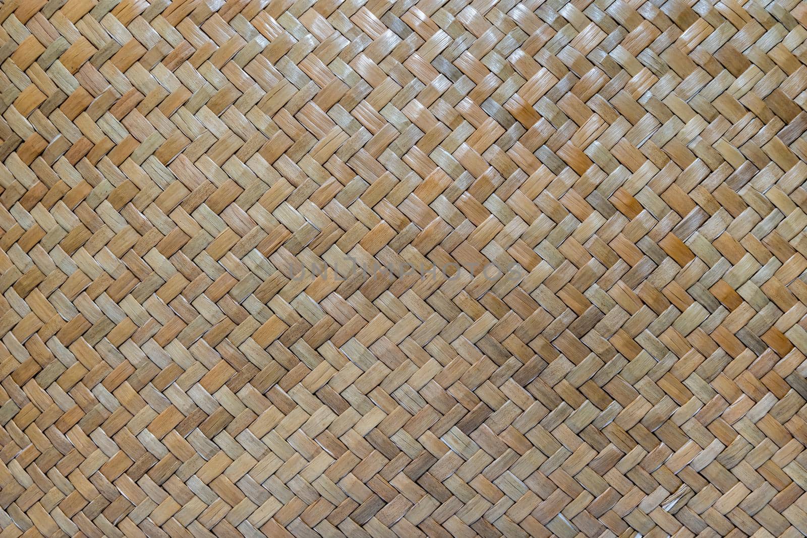 Abstract wicker texture of bamboo weaver which made of pieces of bamboo tiles weaved together. Bamboo wicker basket texture.