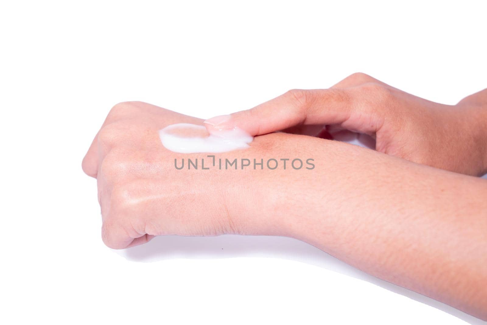 Closeup woman applying protective cream on hands. by Ballstertrw