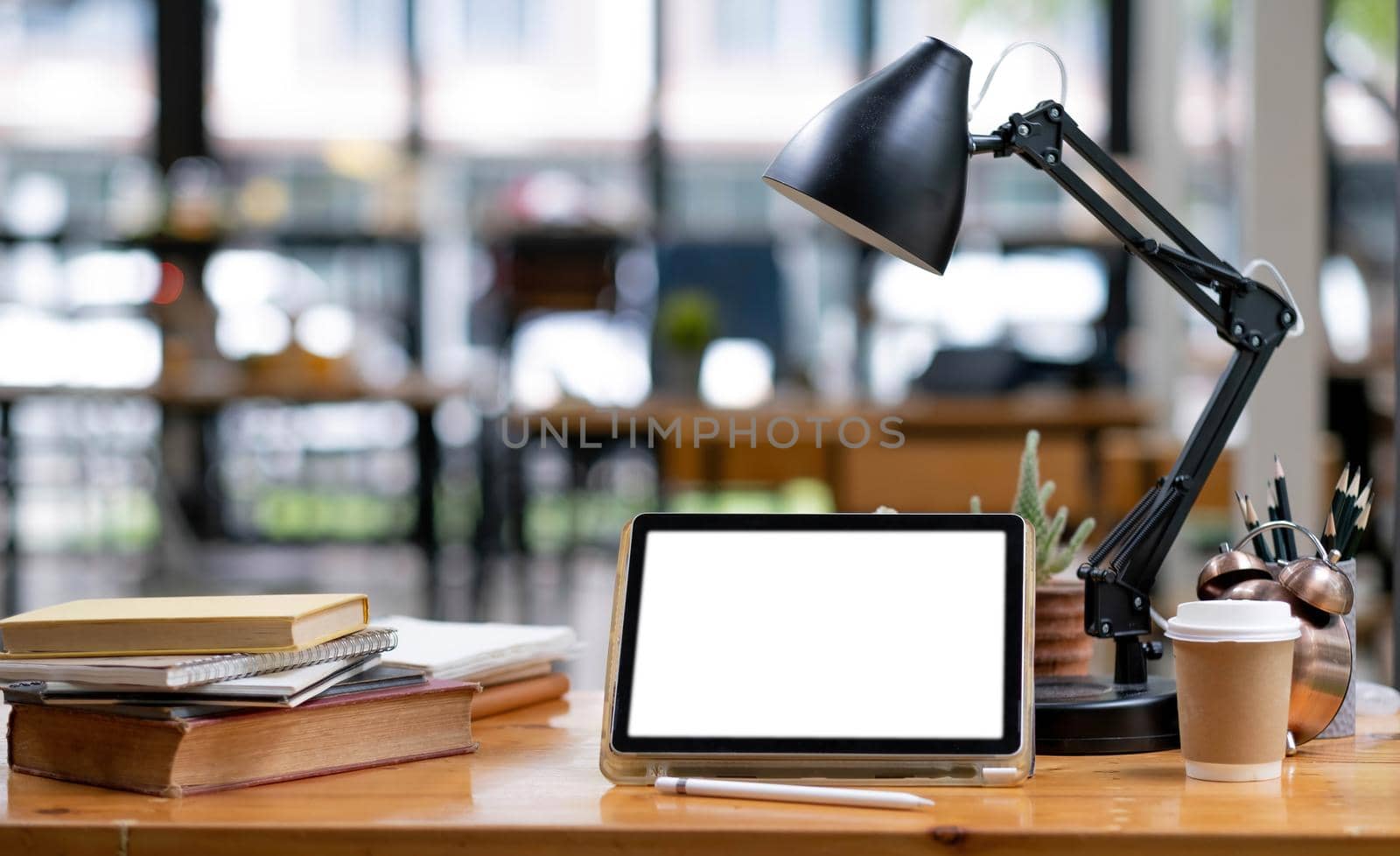 Close-up of a white screen tablet placed at the office. Mock up. by wichayada