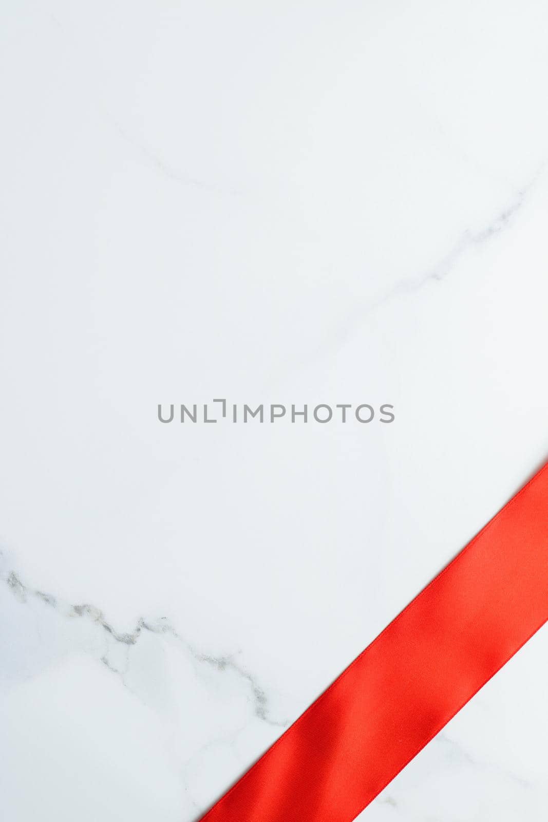 Holiday decor, feminine design and flatlay concept - Red silk ribbon on marble, top view