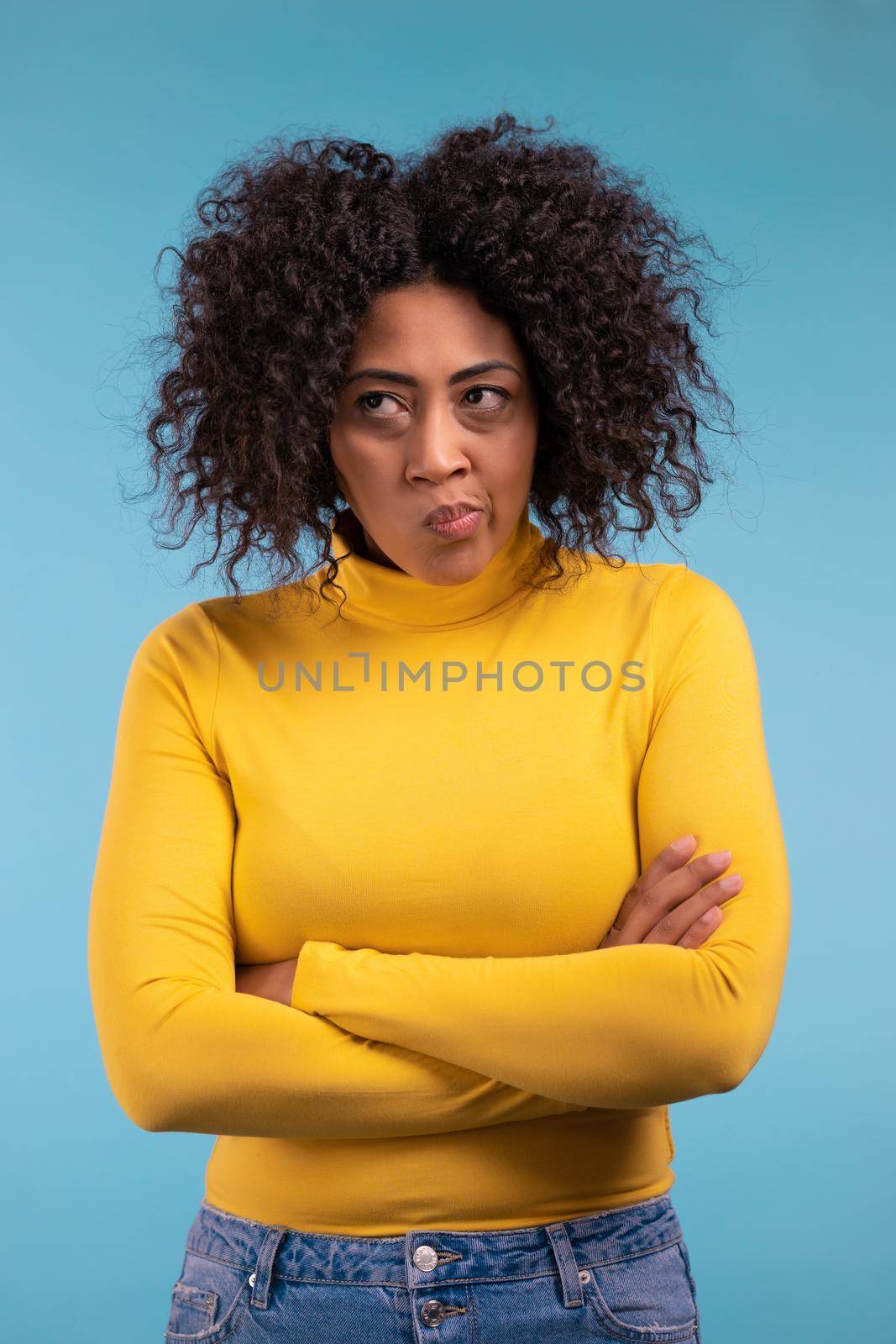 Offended african woman keeping arms crossed, feeling mad at someone. Human facial expressions, emotions and feelings. Body language. High quality photo