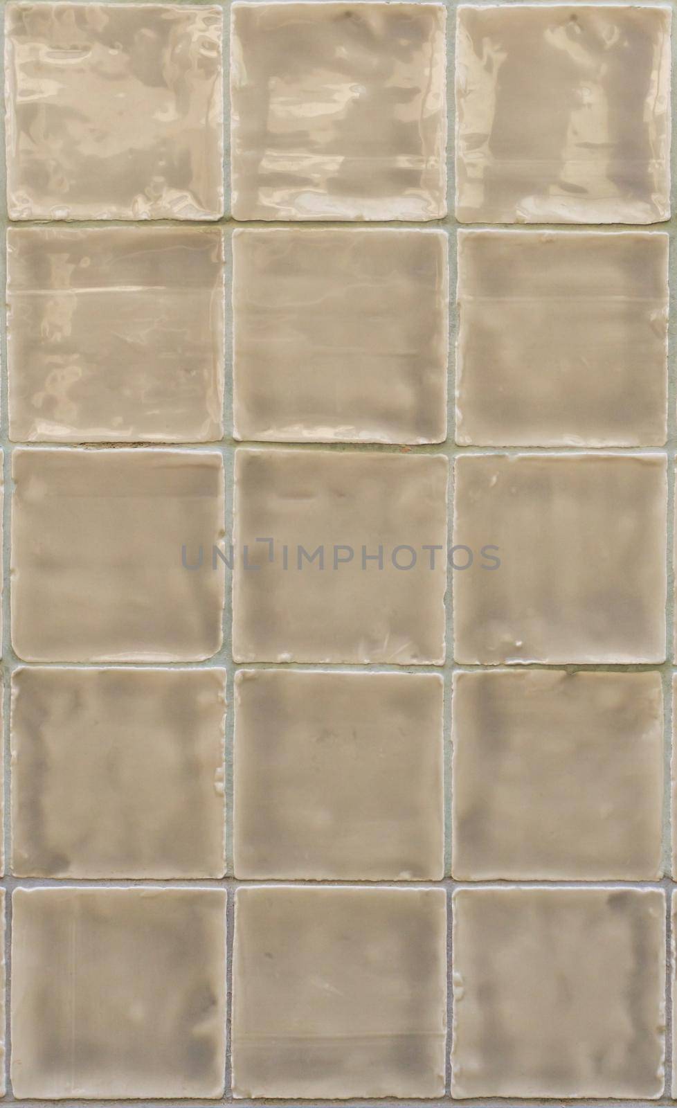 Glossy beige tiles close up background