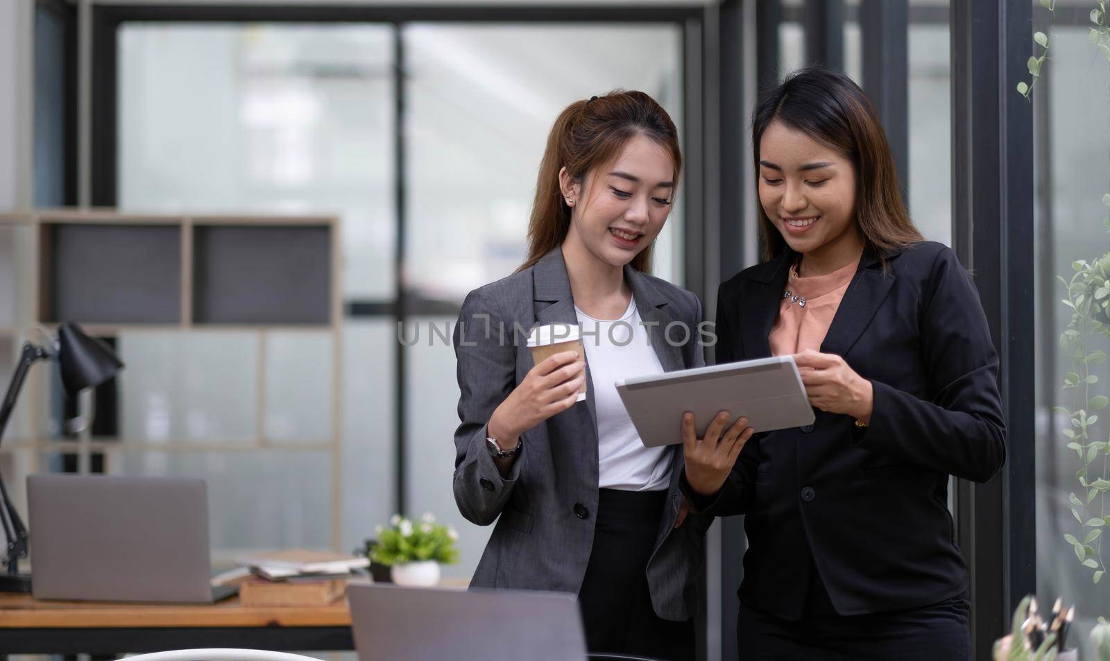 Concept business woman working and people happy businesswoman or creative female office worker with computers writing to notebook with documents and laptop. by wichayada