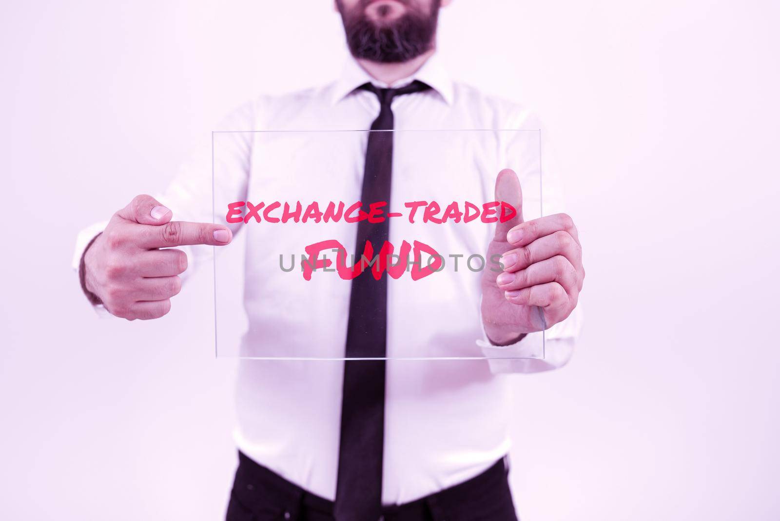 Sign displaying Exchange Traded Fund, Business overview Marketable security that tracks a stock index Piece Of Carboard With Important Message Surrounded By Colorful Paperclips.