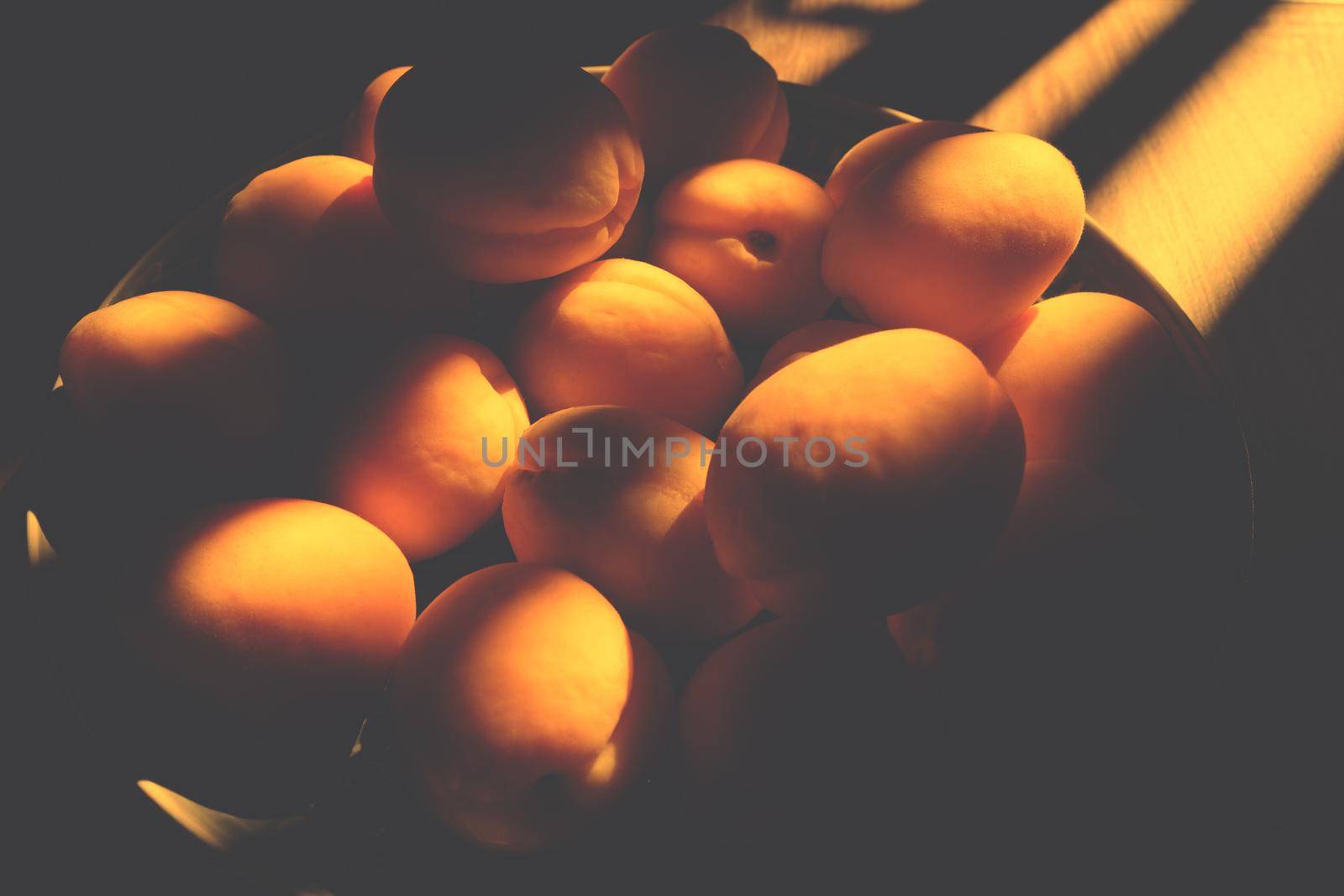 Delicious ripe apricots with hard light. horizontal photo