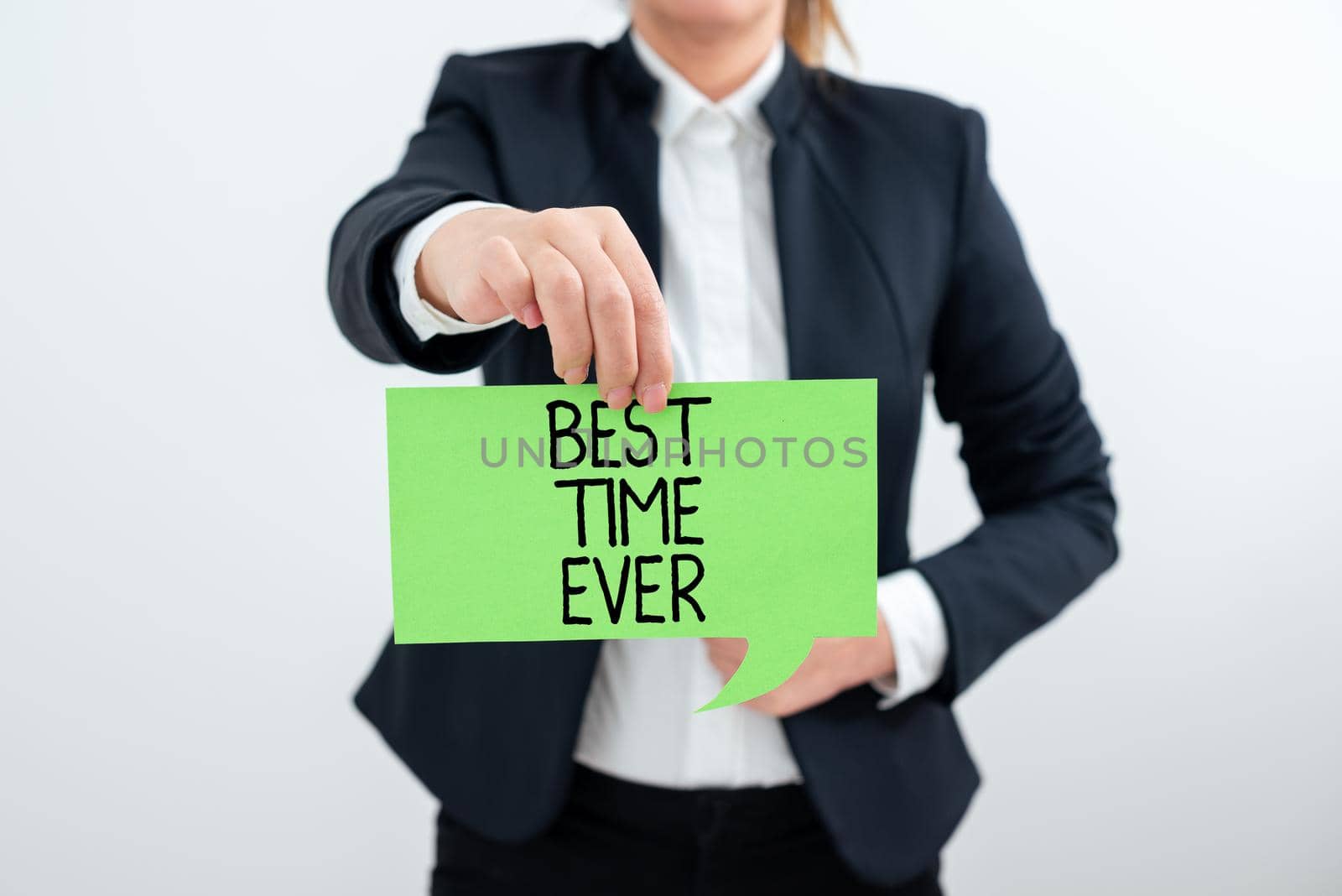 Text sign showing Best Time Ever. Concept meaning Be excited for what is happening at the moment Cheerful Businesswoman In Suit Holding New Important Message Between Hands. by nialowwa