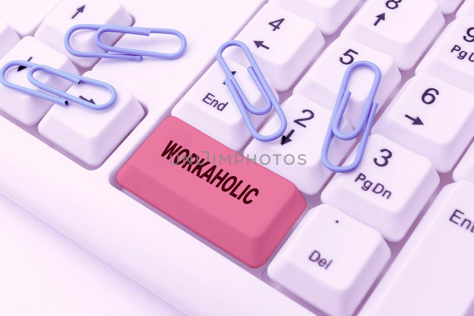 Writing displaying text Workaholic. Business showcase Person who compulsively works excessively hard and long hours Important Message Presented On Clipboard On Desk With Flower And Keyboard. by nialowwa