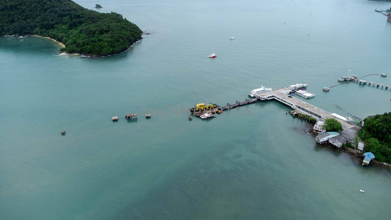 Aerial view from drone of commercial ship and cruise ship parked in the marina. Transportation and travel background, beautiful sea in summer.