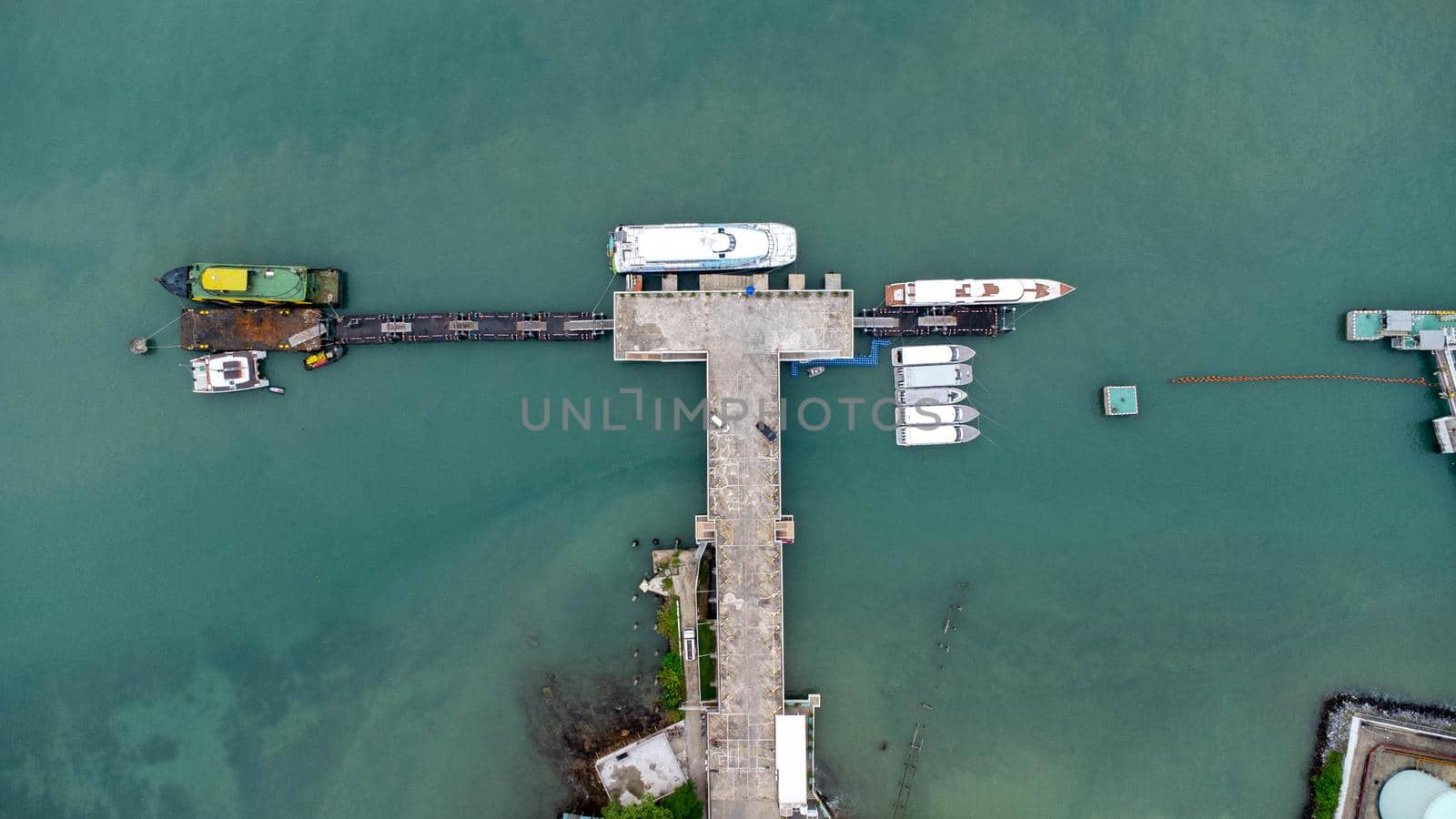 Aerial view from drone of commercial ship and cruise ship parked in the marina. Transportation and travel background, beautiful sea in summer.