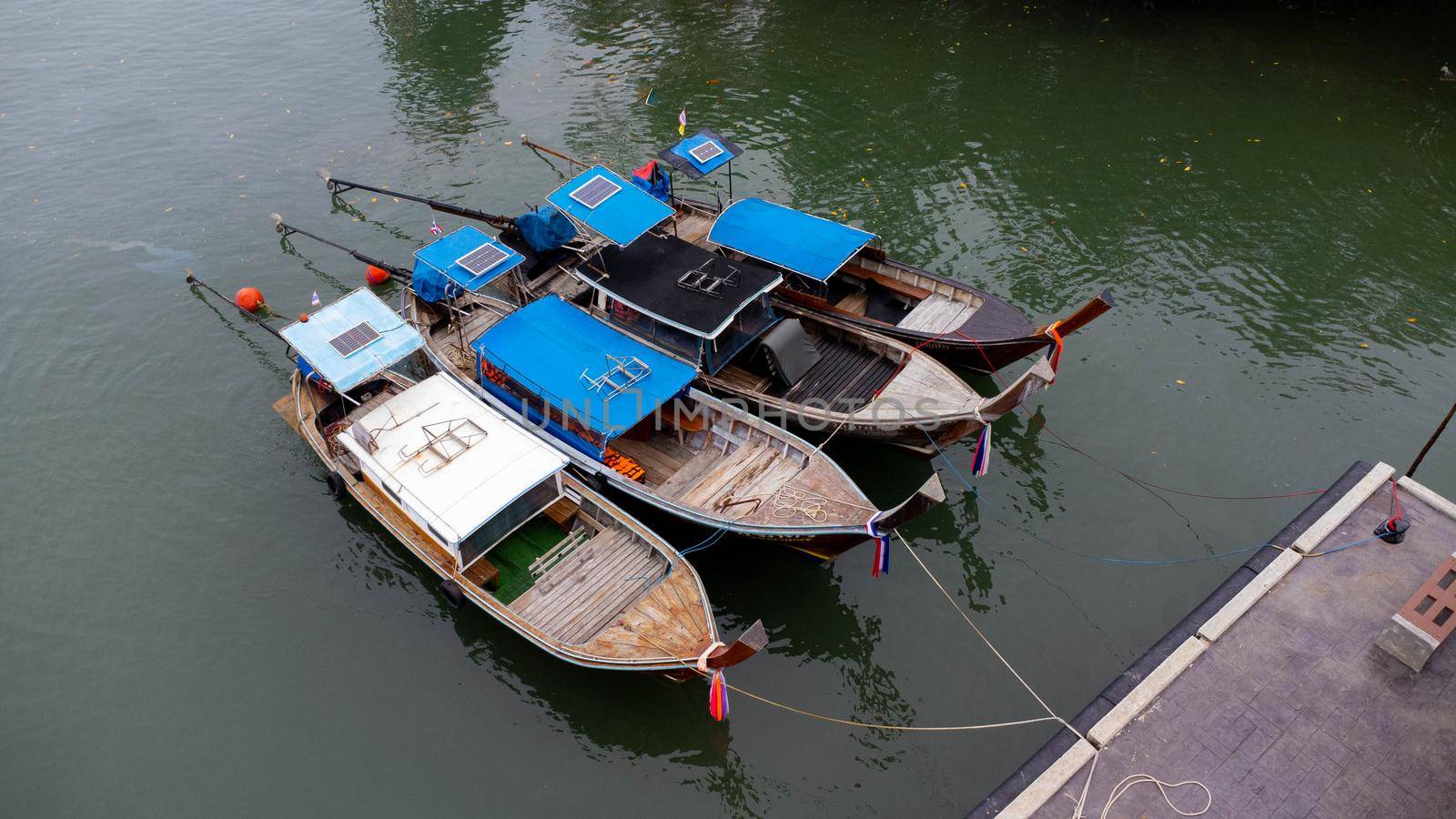 Aerial view of Thai traditional longtail fishing boats at the pier. Transportation and travel concept.