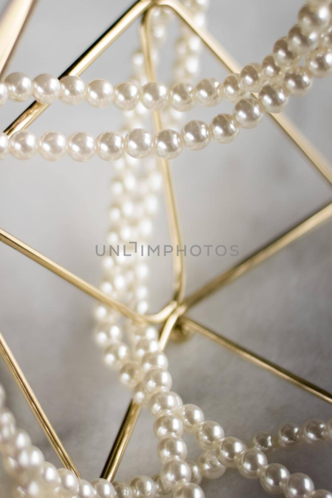 Pearl necklace on golden marble, ethical jewellery - luxury background, jewelry as a gift concept. Pearls are girl's best friends