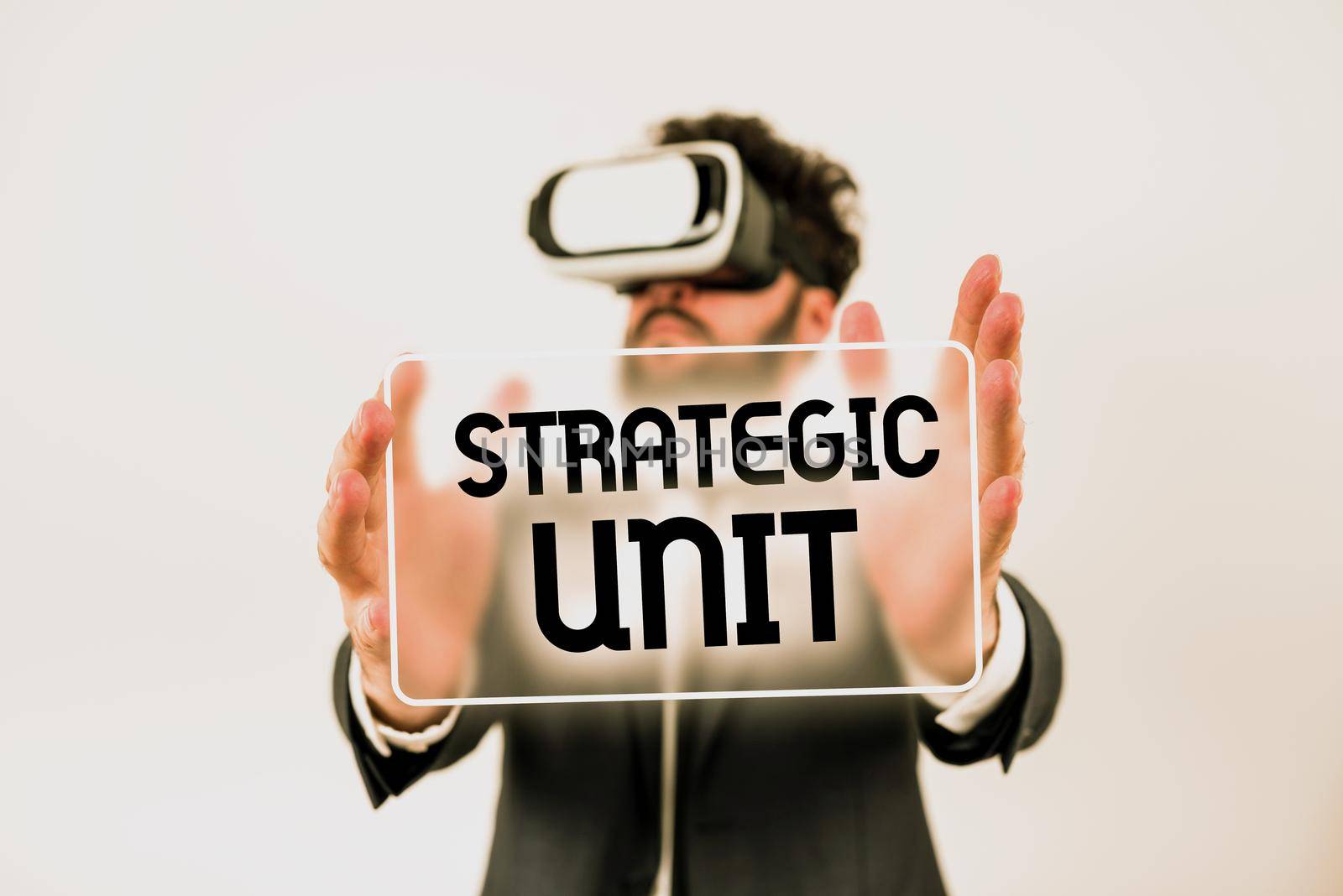 Text caption presenting Strategic Unitprofit center focused on product offering and market segment.. Business overview profit center focused on product offering and market segment. Businessman Pointing Important Informations With Pen In Hand. by nialowwa