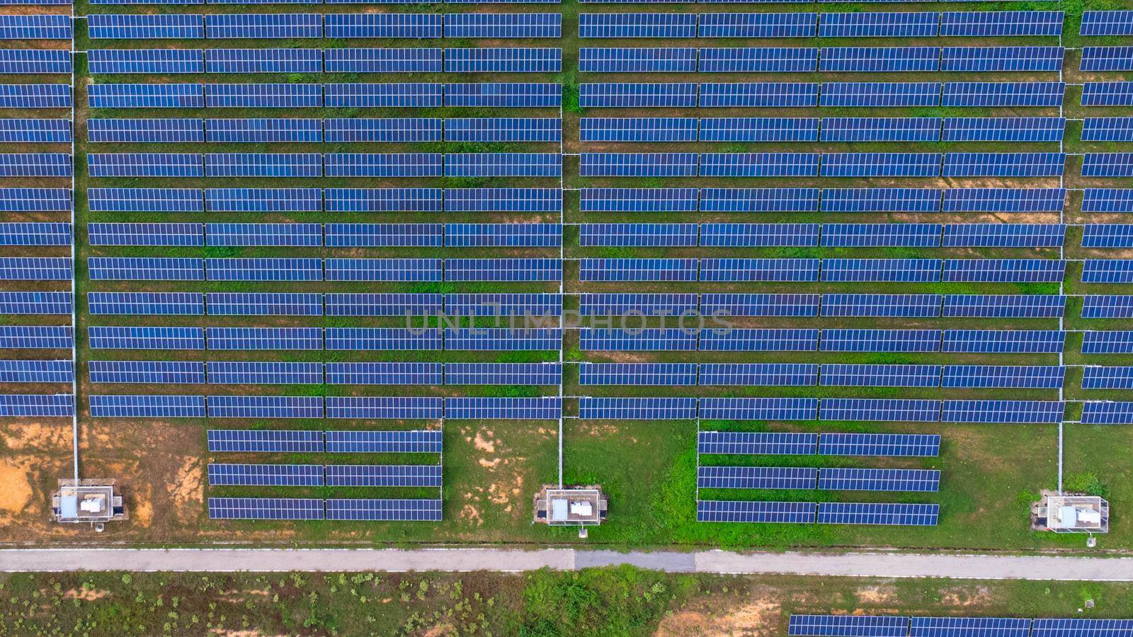 Aerial view of solar panels on a sunny day. A large photovoltaic plant in northern Thailand. Electric farms produce clean energy.