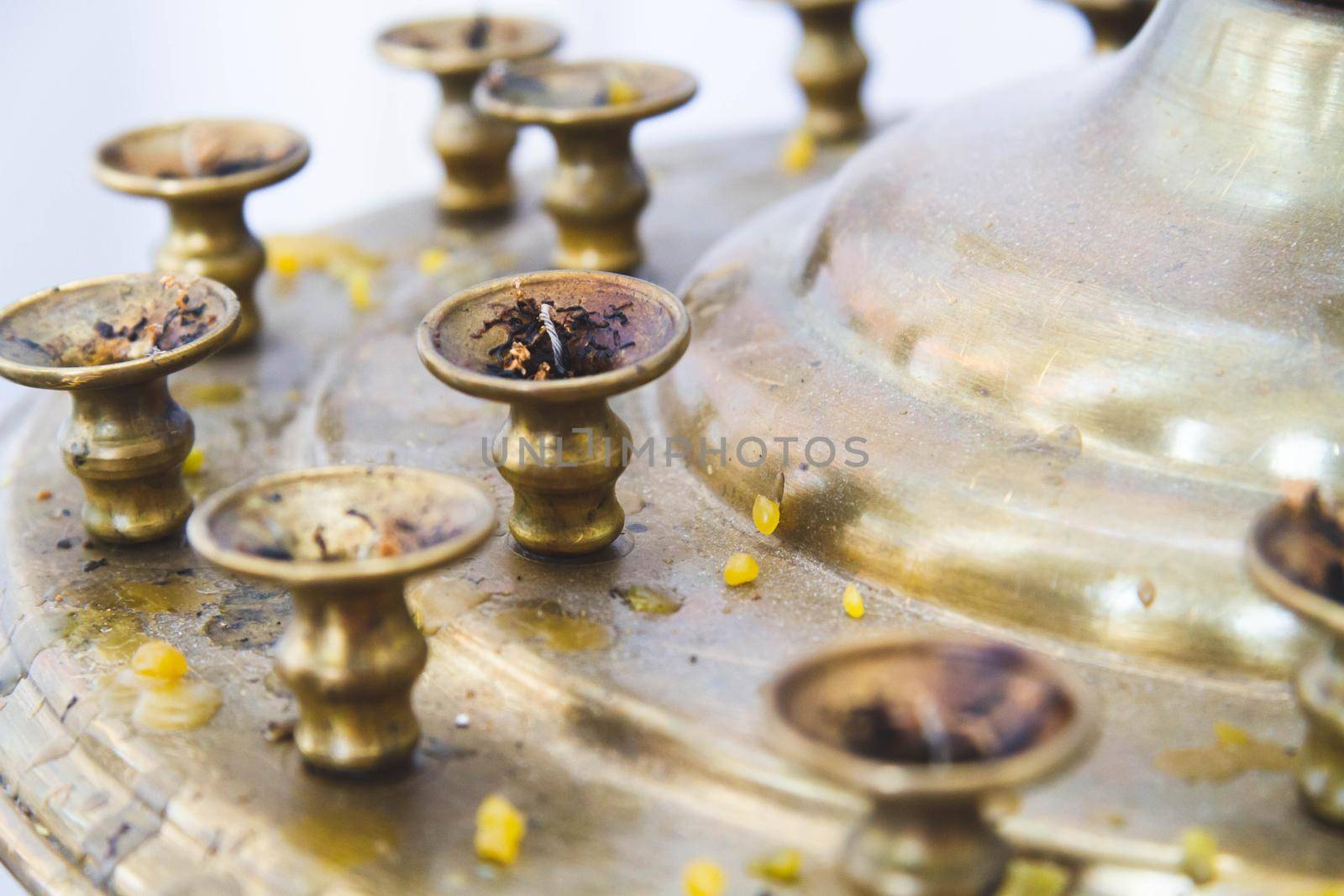 Church candles. Candle stand in the church. Lighting the Fire and prayer in the temple. Religious offerings.