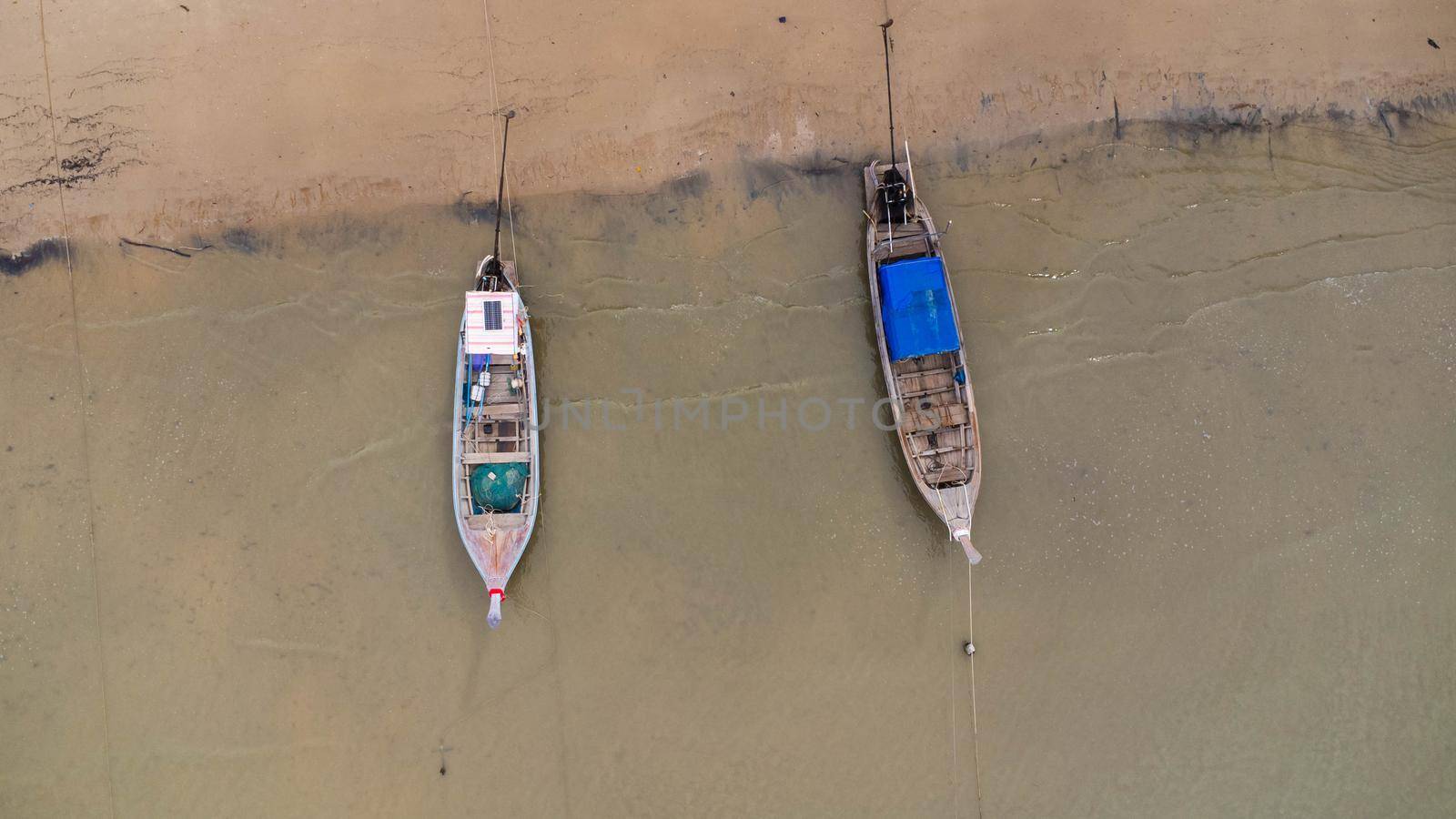 Many fishing boats near the seashore in tropical islands. Pier of the villagers on the southern island of Thailand. top view from drones.