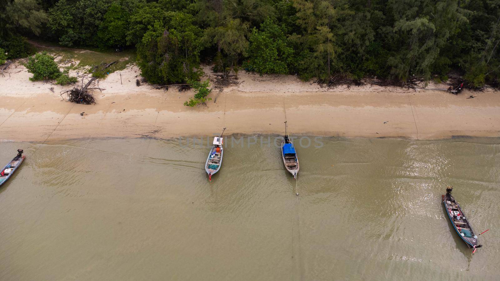 Many fishing boats near the seashore in tropical islands. Pier of the villagers on the southern island of Thailand. top view from drones.