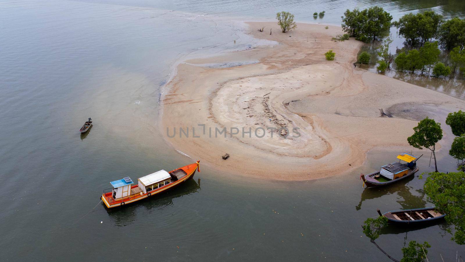 Aerial view of small boats on the beach with mangrove forest in Ao Thalane, Krabi, Thailand.