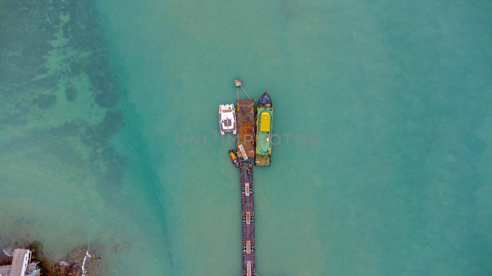 Aerial view from drone of commercial ship in the wharf. Transportation and travel background, beautiful sea in summer. by TEERASAK