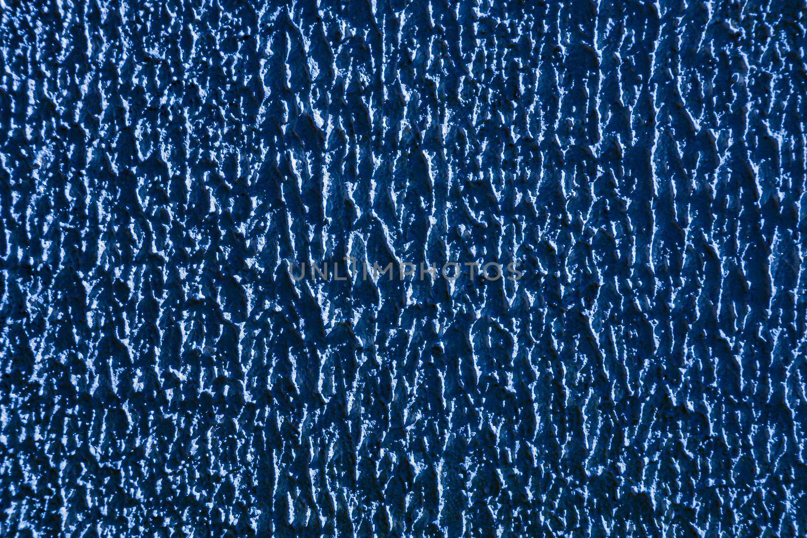 Abstract background of blue rough relief plaster on wall.