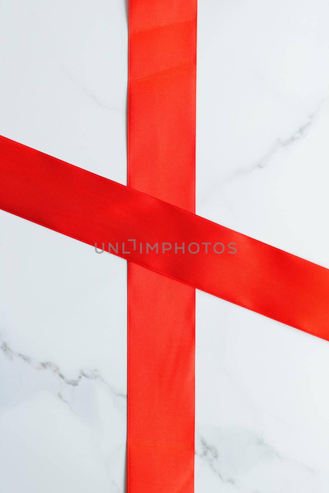 Holiday decor, feminine design and flatlay concept - Red silk ribbon on marble, top view