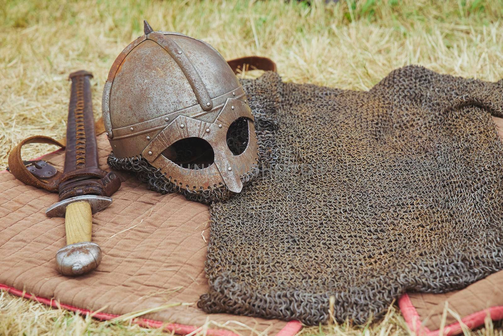 Old Viking armor on yellowed grass. Viking Festival in Denmark