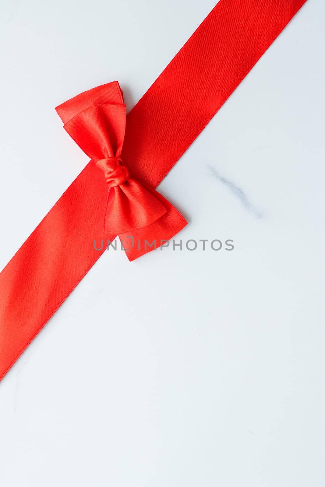 Holiday decor, feminine design and flatlay concept - Red silk ribbon on marble, top view