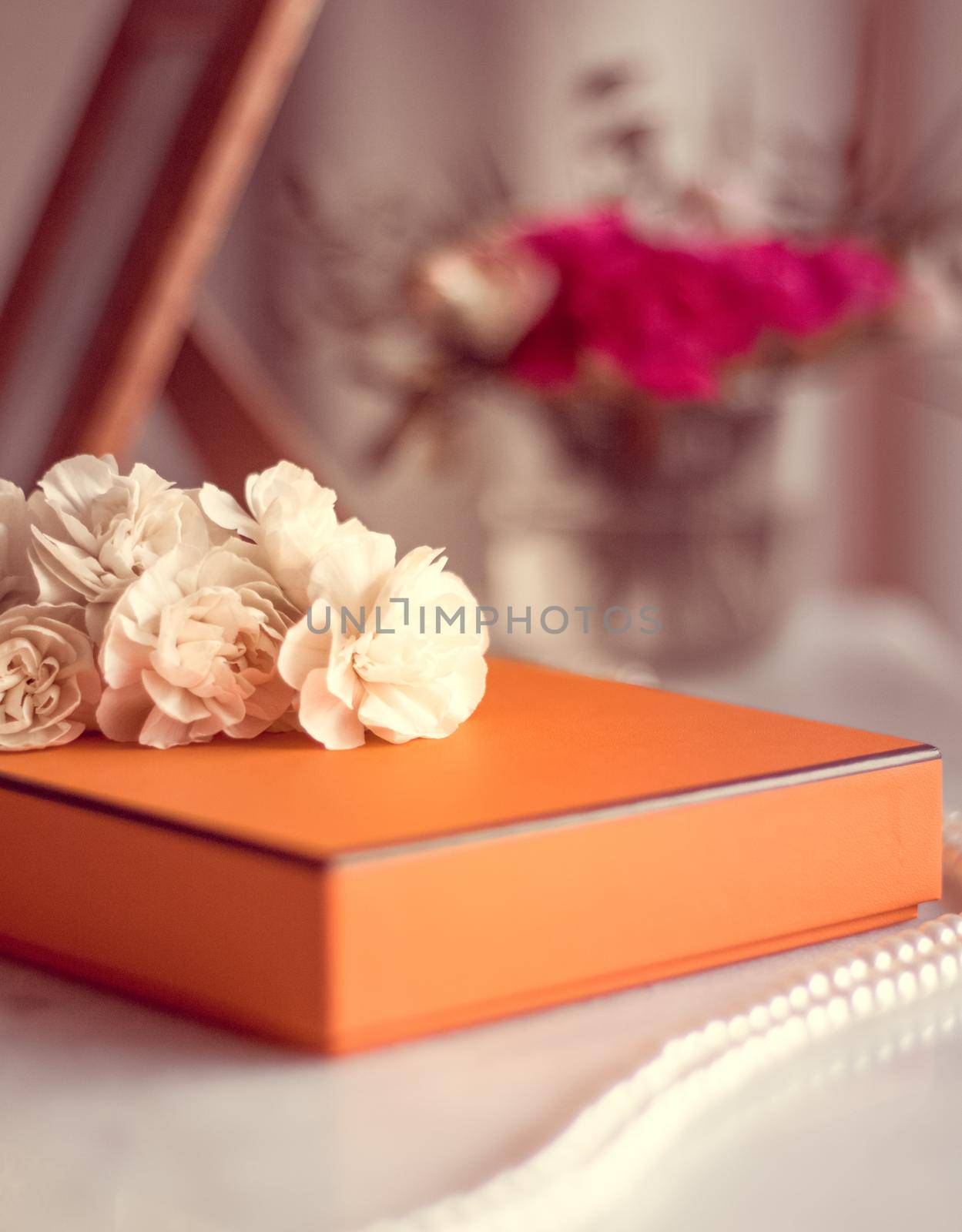 Present box and flowers for her - Mother's day ideas, happy giving and holiday inspiration concept. The perfect gift for mom