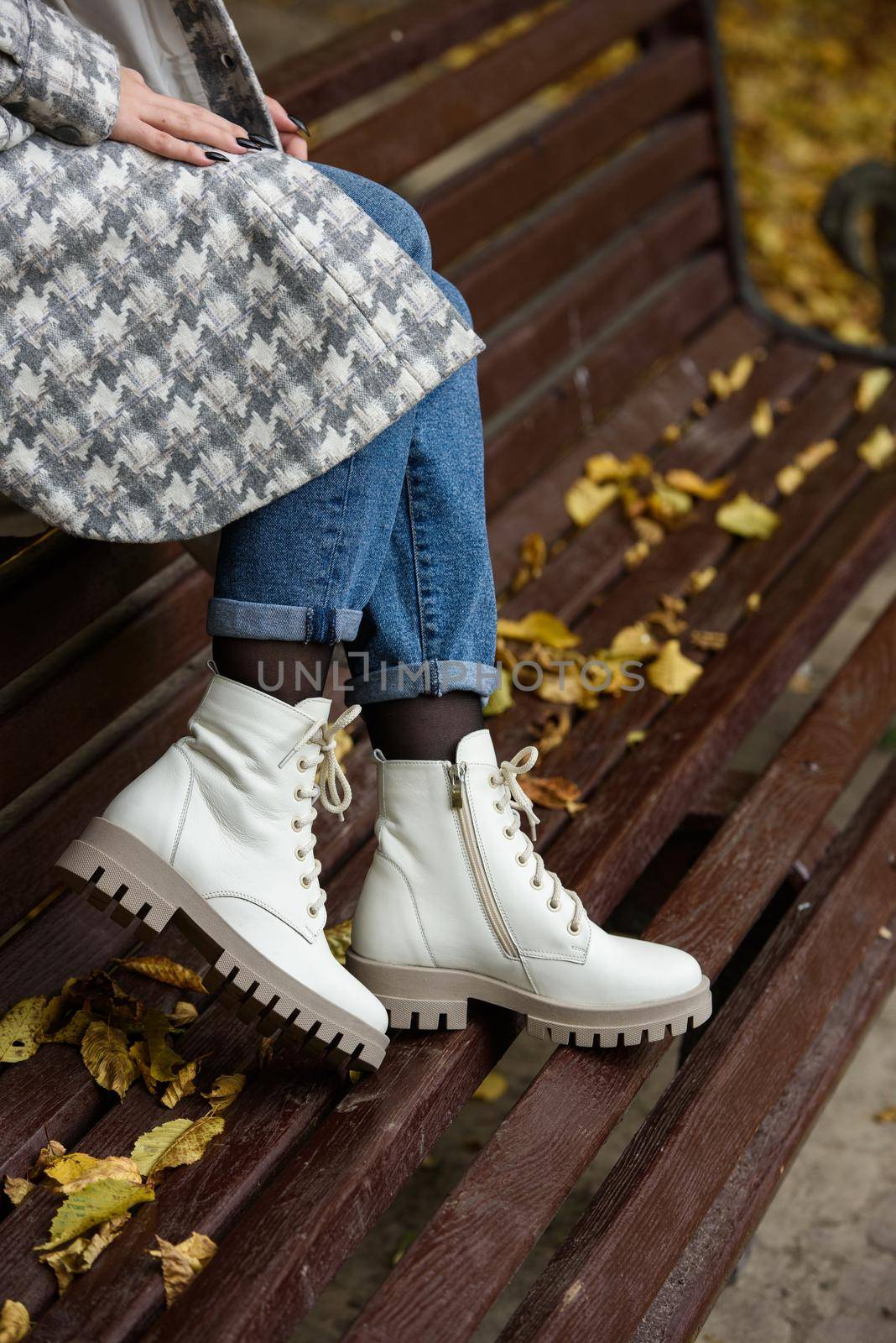 Female legs in a jeans and white fashion boots with laces. by Ashtray25